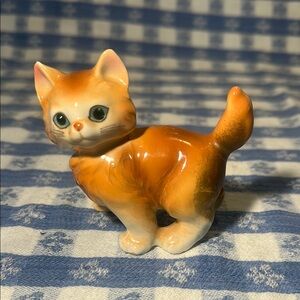 Vintage ceramic Orange Cat Figurine with green emerald sparkly eyes.